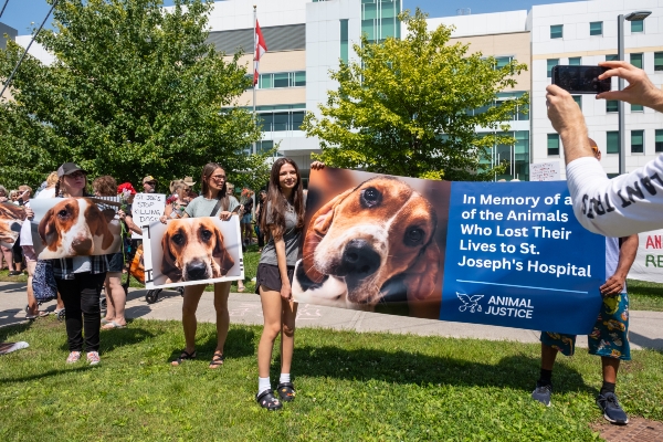 Supporters with Signs. One reads: In memory of all the animals who lost their lives to St. Joseph's Hospital