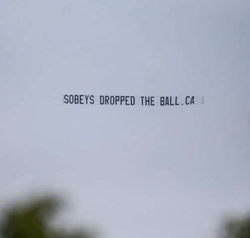Sign from plane flying over National Open reading: SobeysDroppedTheBall.ca