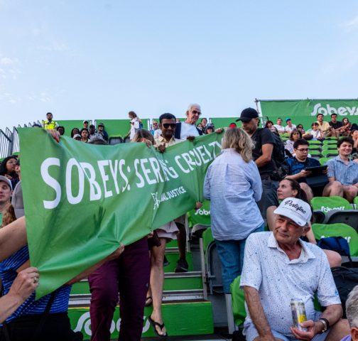 Supporters hold sign: Sobeys: Serving Cruelty