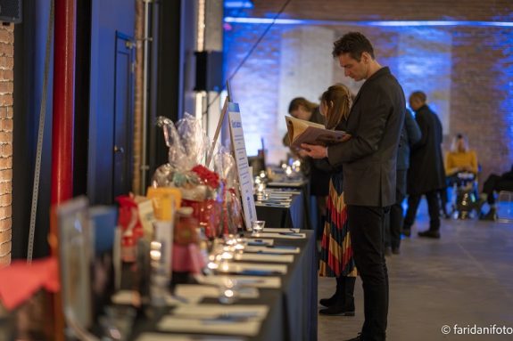 Guests bid on silent auction items at the Animal Justice Holiday Party