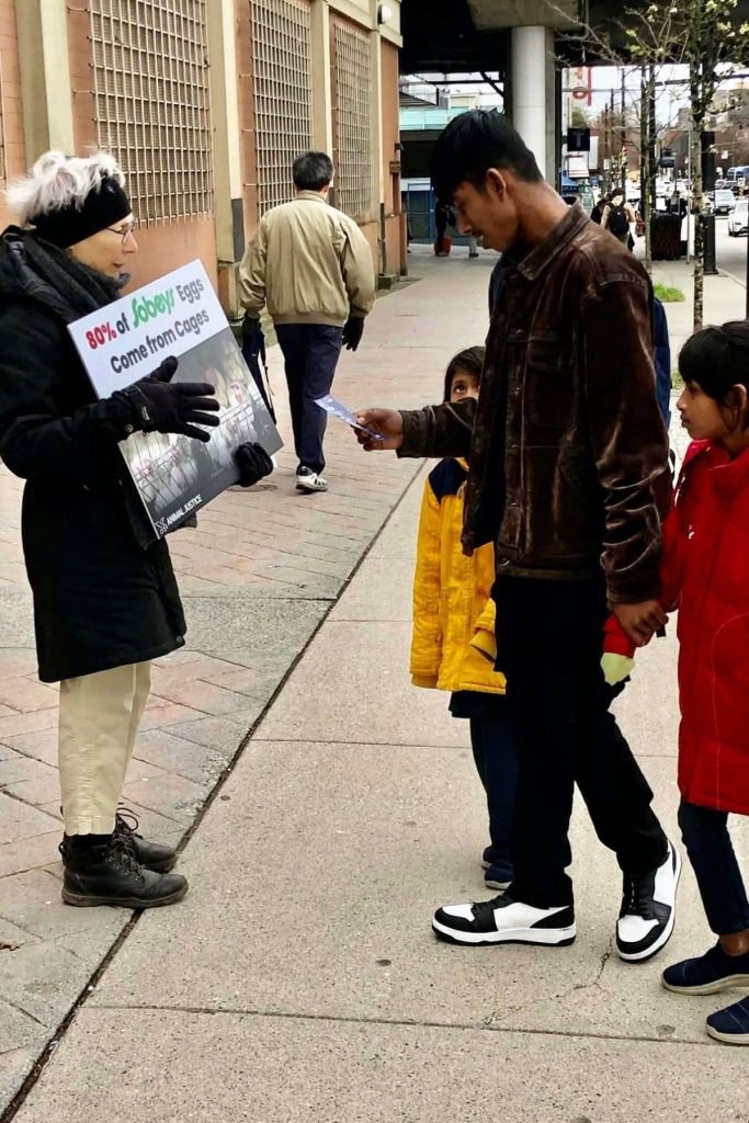 Vancouver residents receive leaflets at EggSCANada launch event.